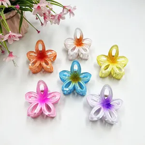 Close-up of six pieces gradient color hollow plumeria hair claws in various vibrant shades