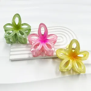 Hollow plumeria flower hair claws in gradient green, pink, and yellow resin finish