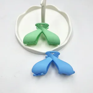 Close-up of mint green and light blue matte bow hair claws on a white display tray