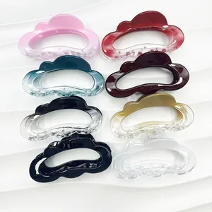 Cloud-shaped shark hair claws in eight assorted colors on a textured white background
