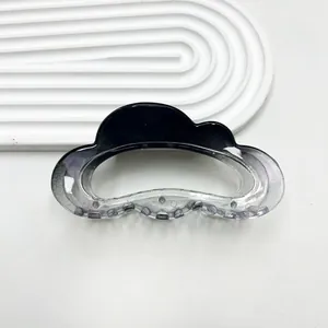 Detailed view of cloud-shaped hair claw clip with black grey gradient and fine glitter