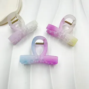 Detail of matte jelly resin hair clips in pastel gradient colors and metal spring mechanism