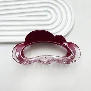 Close-up of cloud-shaped claw clip with burgundy to purple gradient and acrylic finish