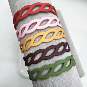 Close-up of matte braided hollow leaf headbands in red pink yellow brown and green colors