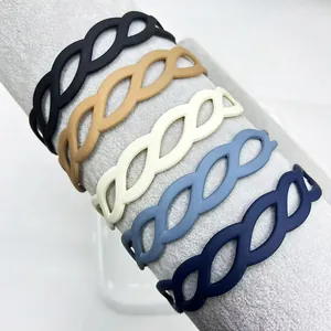 Macro shot of matte hollowed weave headbands in five soft colors on a display stand