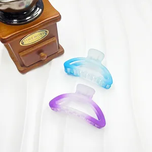 Detail view of semi-circular frosted hair claws in gradient blue and purple colors