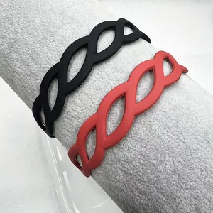 Detail of matte twisted headbands in black and coral red with woven texture design