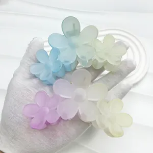 Detailed close-up of matte 11cm gradient frangipani flower hair claws in pastel colors