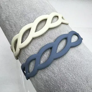 Detail of matte hollow weave headbands in beige and navy blue on a display stand