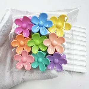 Set of nine colorful candy-colored flower hair claws in a transparent plastic package