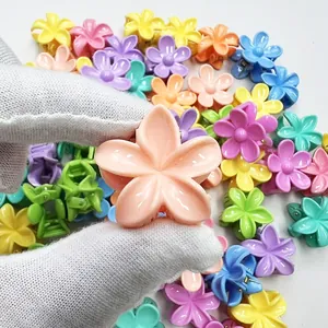 Close-up of colorful 3cm frangipani flower hair claws in assorted macaron shades