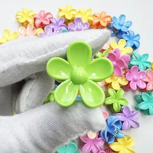 Close-up of a mini 3cm candy-colored plumeria flower hair claw clip for kids