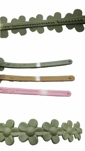 Close-up of matte flower hair hoop parts with mold detail and textured resin surface