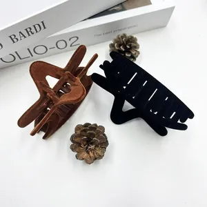 Elegant flocked star hair claws in black and brown velvet finish for autumn and winter