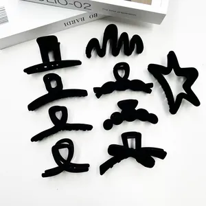Elegant 9-piece set of black flocked hair claw clips in various geometric designs on white background