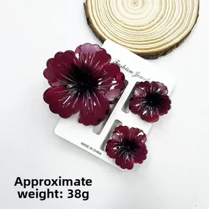 Three-piece burgundy floral hair claw clip set on display card weighing about 38g