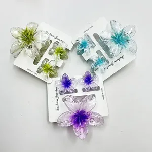 Detailed set of plumeria hair claws in gradient green, blue, and purple resin finish