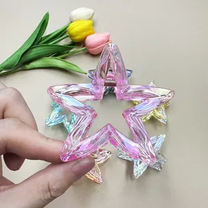 Close-up of pink iridescent star hair claw clip with metallic spring for daily hair styling