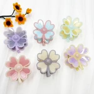 Set of six colorful floral hair claw clips with pearls on a clean white background