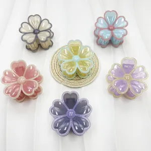 Pinces à cheveux fleurs transparentes en six couleurs sur fond blanc texturé