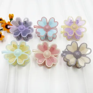 Set of six floral hair claws in pastel colors with heart-shaped resin petals