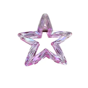 Star-shaped hair claw clip with holographic purple finish and metallic spring mechanism