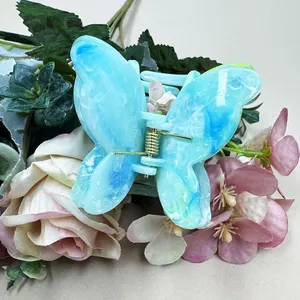 Detail view of double-layer marble texture butterfly hair claw clip with blue resin finish