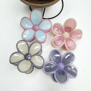 Detail of four colorful jelly resin flower hair claws in blue, pink, white and purple tones
