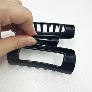 Close-up of black hollow rectangular hair claw clip showing flexible handle and structure