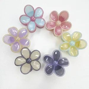 Set of six colorful resin plumeria flower hair claws in pastel cream jelly colors