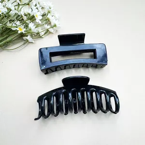 Set of two black matte shark hair clips including rectangular and curved claw designs