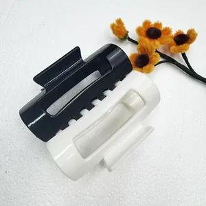 Detail view of large rectangular black and white two-tone matte hair claw clip