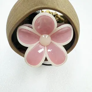 Macro view of jelly pink flower hair claw with white edges and glossy resin finish