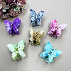 Set of six double-layered marble butterfly hair claws in various vibrant pastel colors