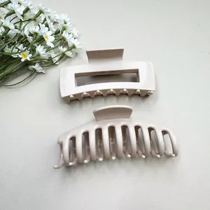 Detail of matte beige rectangular and semi-circle soft silicone shark hair clips