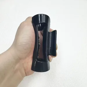 Close-up of large black silicone hair claw clip showing glossy finish and size