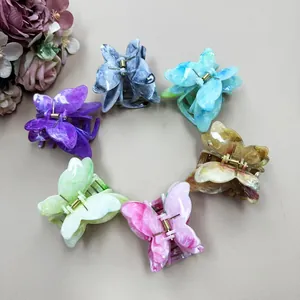 Detailed set of six marble-textured butterfly hair claws in various vibrant colors