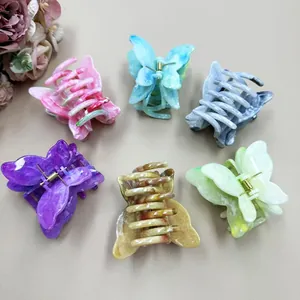 Double-layer marble butterfly hair claws set in six diverse colors on a neutral background