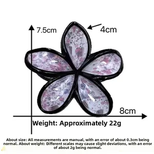 Detailed size view of an 8cm floral hair claw clip with black ink splatter texture