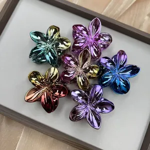 Close-up of metallic gradient flower hair claws in seven vibrant electroplated colors
