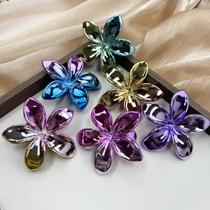 Plated plumeria flower hair clips set with metallic gradient colors and elegant design