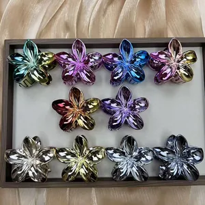 Set of 10 gradient metallic floral claw clips displayed on elegant satin background