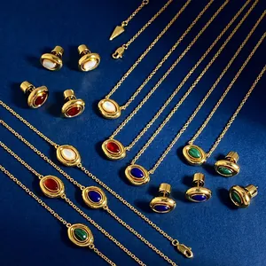 Flat lay of vintage gold jewelry set with oval red agate and malachite stones