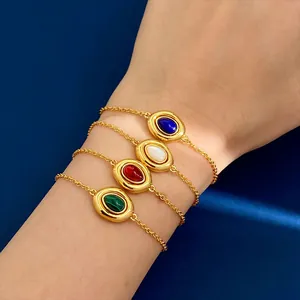 Detail of four vintage oval stone bracelets in gold with agate and malachite on a model
