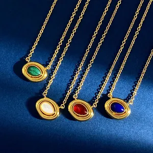Detailed view of vintage gold necklaces with oval malachite, agate, and pearl pendants