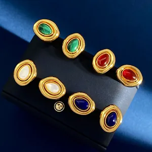 Macro detail of vintage oval gold earrings with malachite, agate, and lapis stones