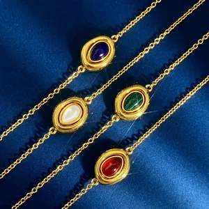 Detail of vintage gold oval necklaces with malachite, agate, and lapis lazuli stones