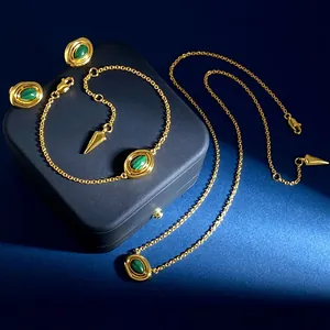 Vintage style gold jewelry set featuring green malachite stones and conical charms