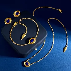 Vintage style gold jewelry set with oval blue stone necklace, bracelet, and stud earrings