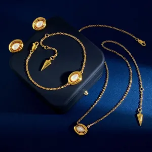 Vintage jewelry set with gold oval natural stones on dark blue background display